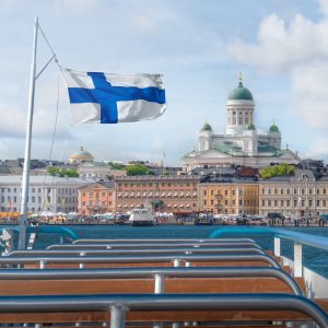 Helsinki skyline boat view with Finnish flag and Helsinki Cathedral - Helsinki, Finland